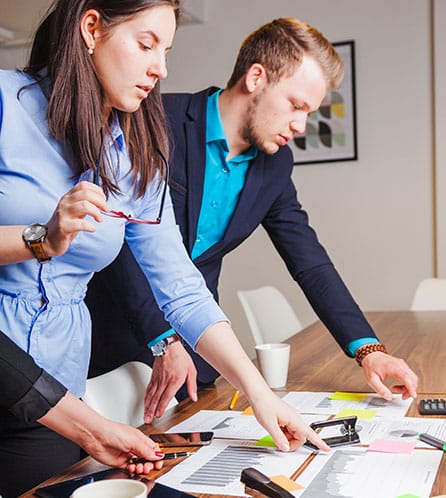 Business team analyzing charts for strategic planning and financial efficiency